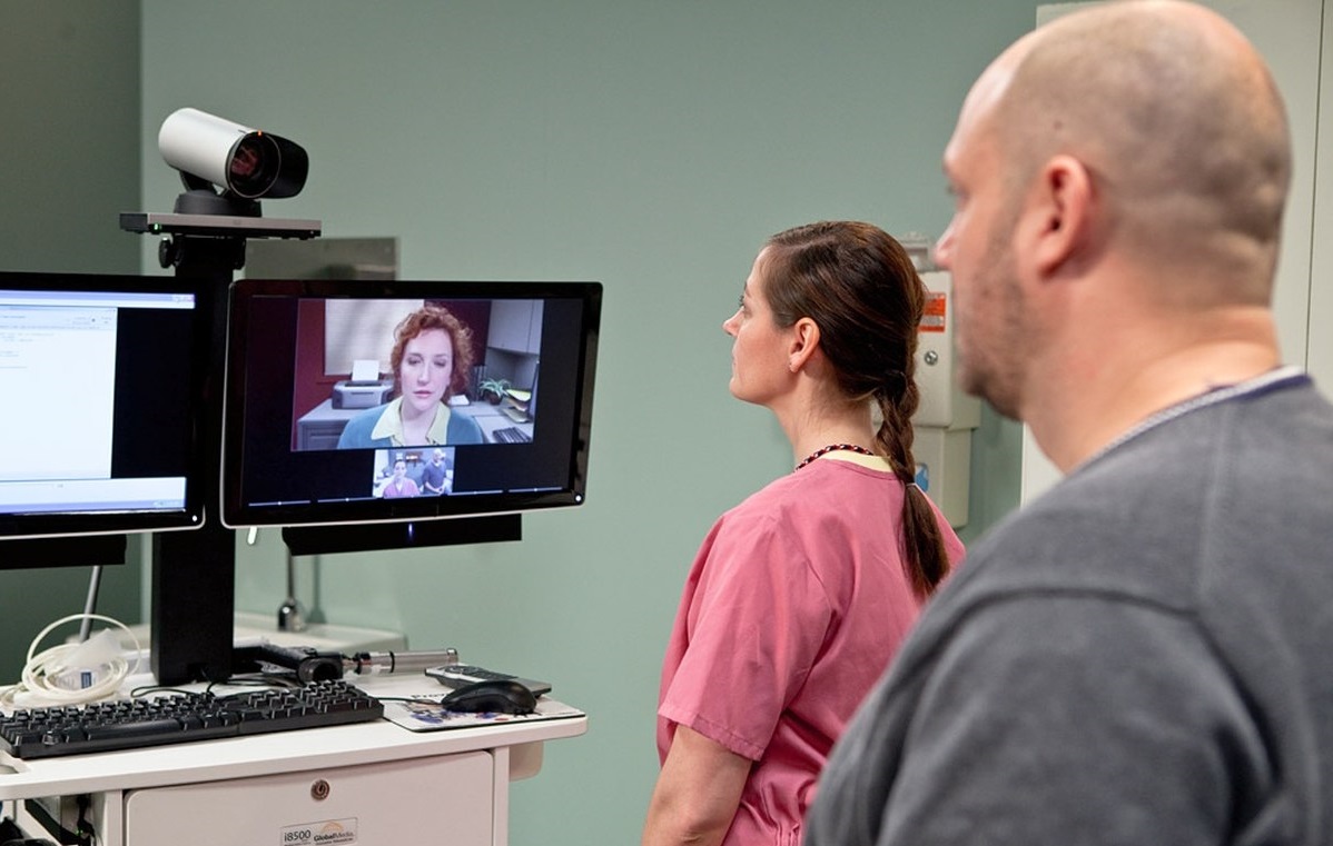 Two medical professionals attending a virtual meeting image